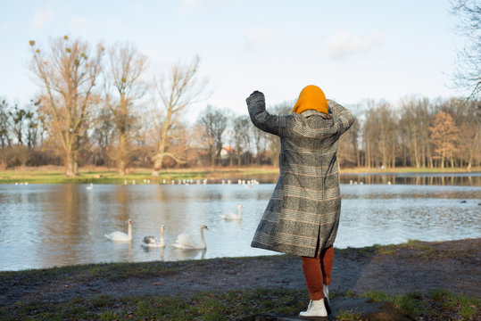 Woman dancing in a park in polto near a lake