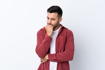 Young handsome man with beard wearing a corduroy jacket over isolated white background having doubts