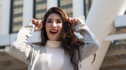 Asian business woman standing and finger up like a eureka action and feeling happy which represent have a brilliant idea, thoughtful, solve problem, imagination, inspiration or clever moment in work