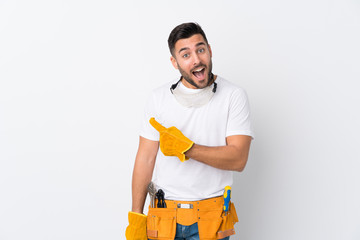 Craftsmen or electrician man over isolated white background pointing finger to the side
