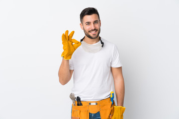Craftsmen or electrician man over isolated white background showing an ok sign with fingers
