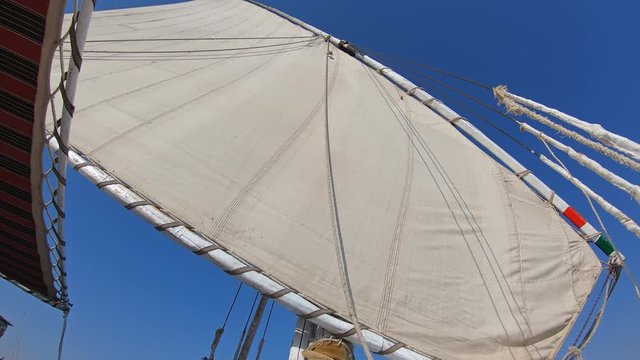 View from below on white sail of felucca boat in Egypt, 4k