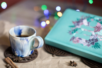 Ceramic coffee Cup, diary and lights. Romantic mood. Breakfast. Lunch