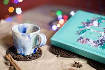 Ceramic coffee Cup, diary and lights. Romantic mood. Breakfast. Lunch