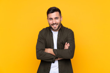 Man over isolated yellow background laughing