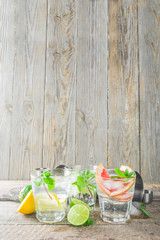 Summer detox beverage  concept. Citrus fruit drinks with ice. Healthy diet cocktail with making bar tools.  Vitamin fortified water
