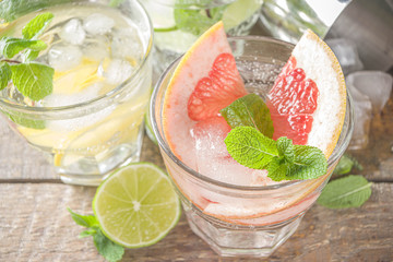 Summer detox beverage  concept. Citrus fruit drinks with ice. Healthy diet cocktail with making bar tools.  Vitamin fortified water