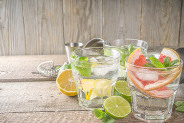 Summer detox beverage  concept. Citrus fruit drinks with ice. Healthy diet cocktail with making bar tools.  Vitamin fortified water