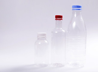 Three empty plastic bottles on a white background