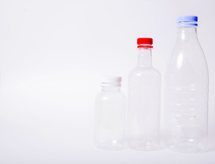 Three empty plastic bottles on a white background