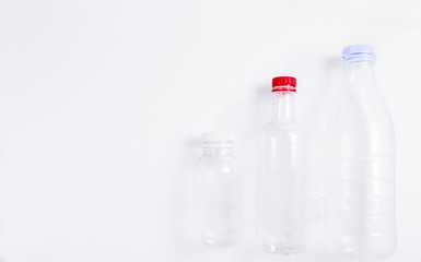 Three empty plastic bottles on a white background