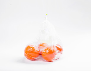 Tangerines with a transparent plastic bag on a white background
