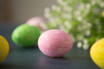 Easter eggs on a gray wooden surface