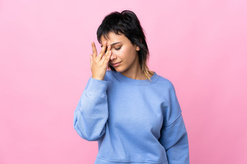 Young Uruguayan woman over isolated pink background with headache