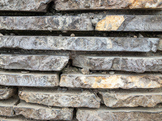 The surface of a stone wall. Masonry walls of old stone blocks.