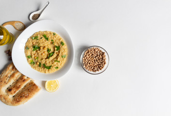 Chikpeas in bowl as main ingredient of hummus on white background