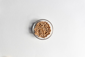 chickpeas in glass bowl close up on white background