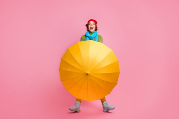 Full length photo of excited amazed girl enjoy winter weekend walk hide jumper sweater with her open parasol wear stylish trendy footwear isolated over pink color background © deagreez
