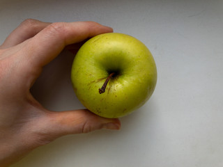 One green Apple in hand. The view from the top.