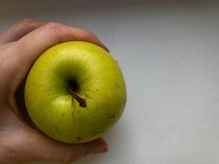 One green Apple in hand. The view from the top.