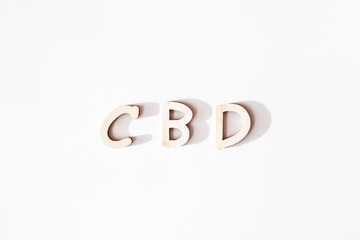 CBD in wood letters on white background