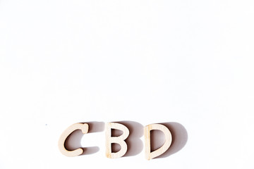 CBD in wood letters on white background
