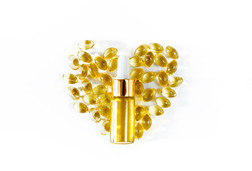 Assorted medical cannabis products  capsules and CBD oil isolated over white background. Heart shaped capsules and bottle