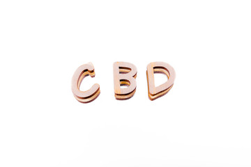 CBD in wood letters on white mirror background