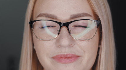 Fototapeta premium Portrait of independent successful young business woman in glasses with beautiful white hair, clear skin and plump lips. Positive feminine background concept. Slow motion close up front view 4K video.