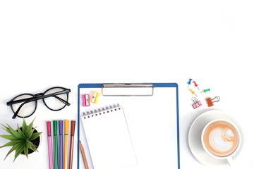 Flat lay education and business concept on white table desk background with blank notepad and highlight marker pen, plant, coffee cup, glasses, stationary, Top view with copy space