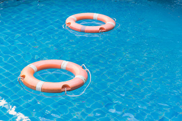 lifebuoys floating in swimming pool.