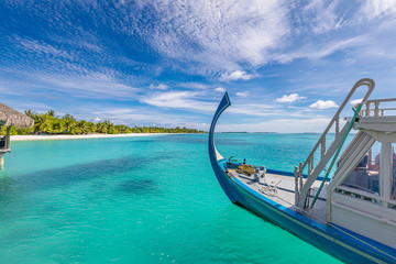 Inspirational Maldives beach design. Maldives traditional boat Dhoni and perfect blue sea with lagoon. Luxury tropical paradise concept. Exotic travel landscape, seascape in Maldives