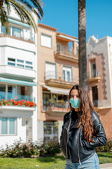 Girl with a mask to protect walking on the street