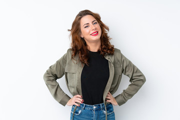 Obraz premium Young Russian woman over isolated white background posing with arms at hip and smiling