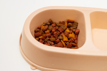 Closeup of dry cat food in a bowl, pet food.