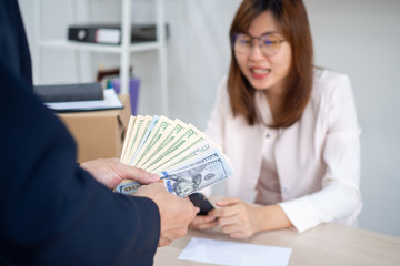 General manager presenting an envelope with premium or bonus cash to female official. Boss congratulating happy employee with career promotion, thanking for good job and giving financial reward
