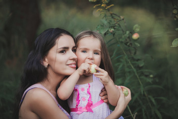 beautiful young mother daughter relaxing sitting grass background summer meadow
