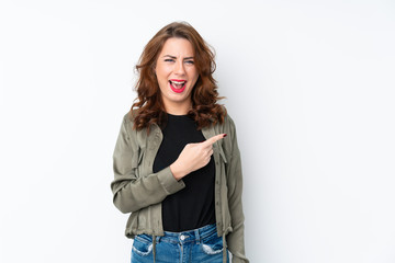 Fototapeta premium Young Russian woman over isolated white background surprised and pointing side
