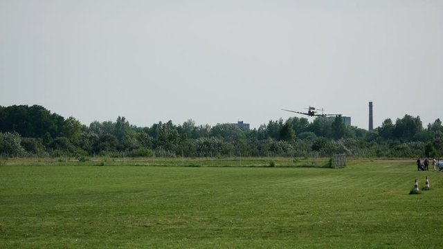 Ultralight small private aircraft airplane flying in the sky over the airfield. Aviation festival holiday at the aerodrome