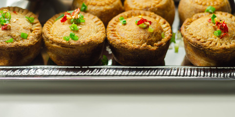 Traditional  English pork pies with cranberry sauce on a silver tray