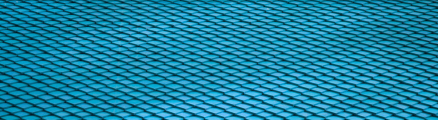 Fototapeta na wymiar Blue ocean geometric tiles, roof shingles texture background. Vintage decoration styles. Overlapped small piece by piece as fish scale pattern.