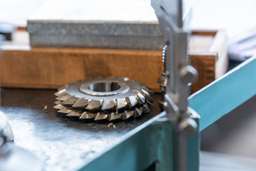 Disc mill for the milling machine, after sharpening lies on the rack.