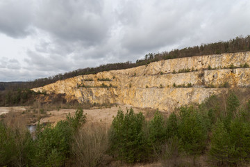 Scenic view over abandoned quarry on overcast day