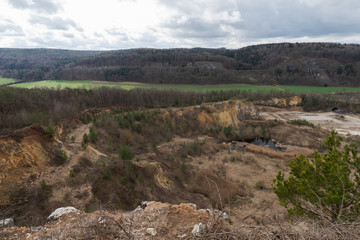 Fototapeta na wymiar Scenic view over abandoned quarry on overcast day