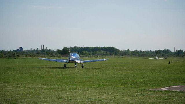 Ultralight small private aircraft airplanes moving on the airfield. Aviation festival holiday at the aerodrome airport