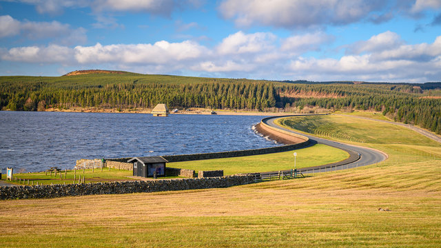 Kielder Dam on a sunny day, at Kielder Water and Forest Park in Northumberland, which has the largest man made lake in Northern Europe. The reservoir sits in the North Tyne Valley
