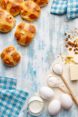 Ingredients to make hot cross buns traditional baking on a wooden background with copy space