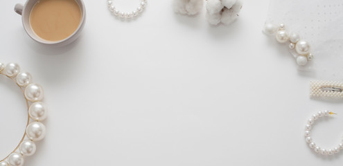 The wedding background with space for text, decorated with invitation envelopes and decorations for the bride, is made in soft pastel colors, with copy space. Conceptual backgrounds for wedding texts.