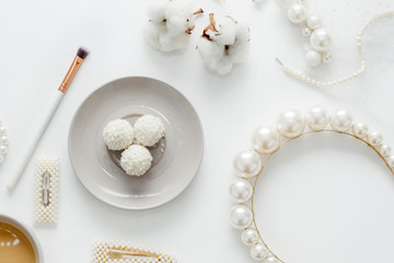 The wedding background with space for text, decorated with invitation envelopes and decorations for the bride, is made in soft pastel colors, with copy space. Conceptual backgrounds for wedding texts.