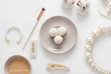 The wedding background with space for text, decorated with invitation envelopes and decorations for the bride, is made in soft pastel colors, with copy space. Conceptual backgrounds for wedding texts.